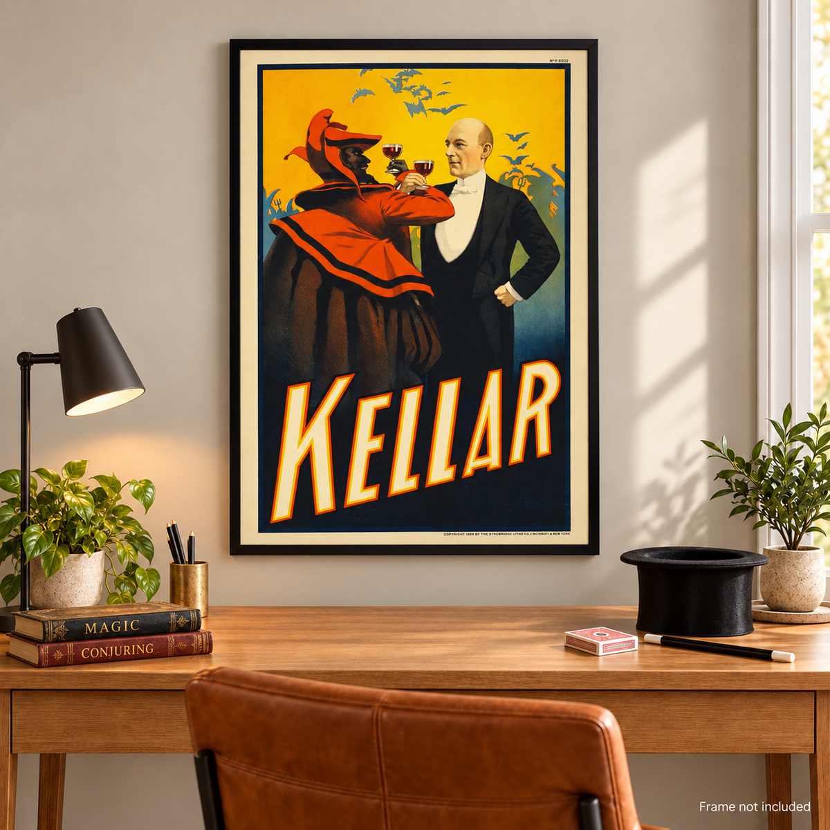 Harry Kellar framed vintage magic poster above wooden desk with magic books top hat cards and wand; frame not included