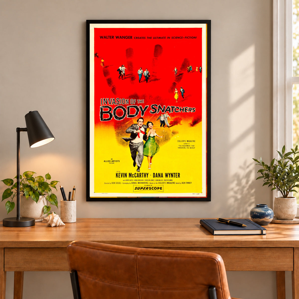 Invasion of the Body Snatchers vintage poster framed above a simple wood desk, frame not included